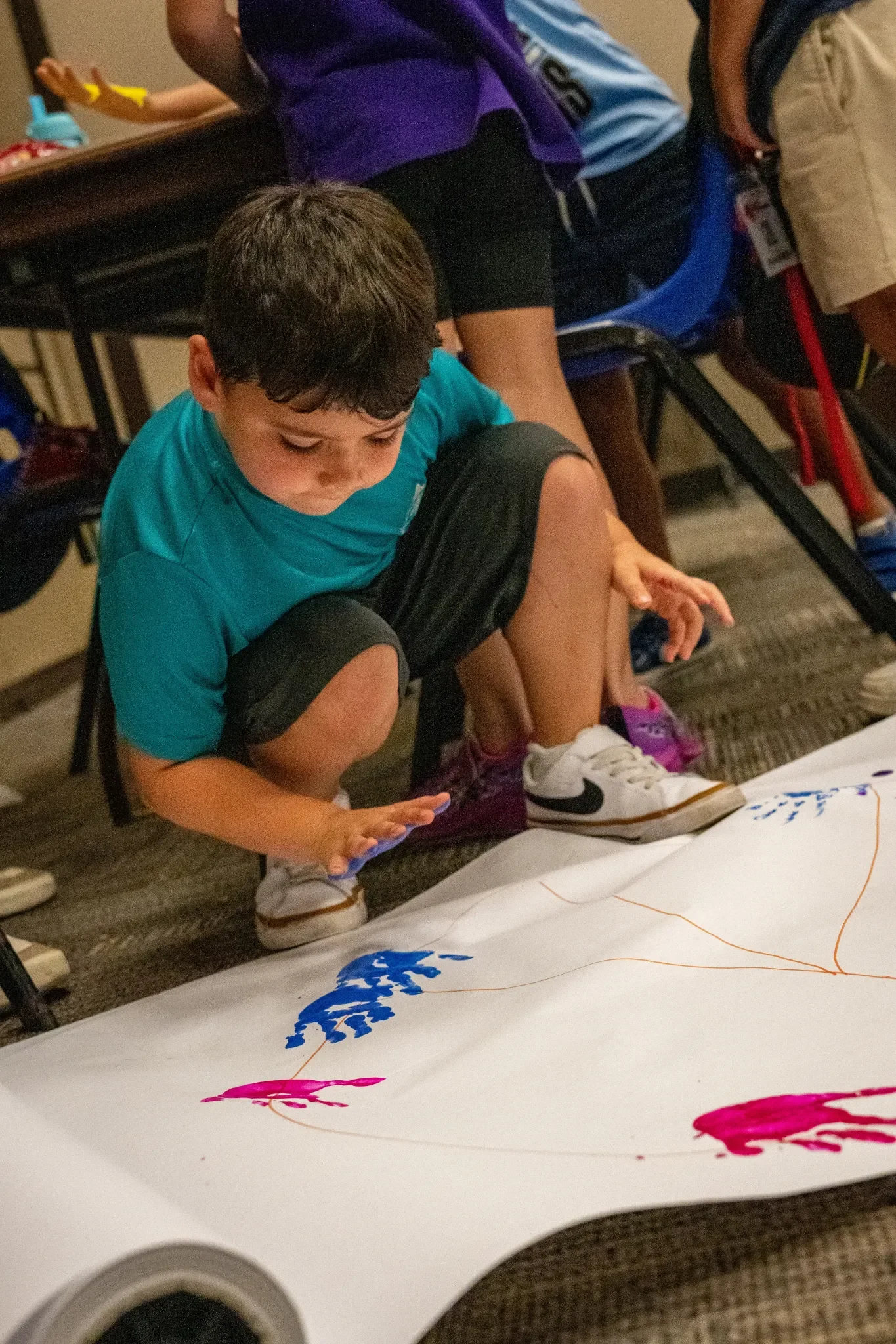 Kid painting at jcc spring break camp