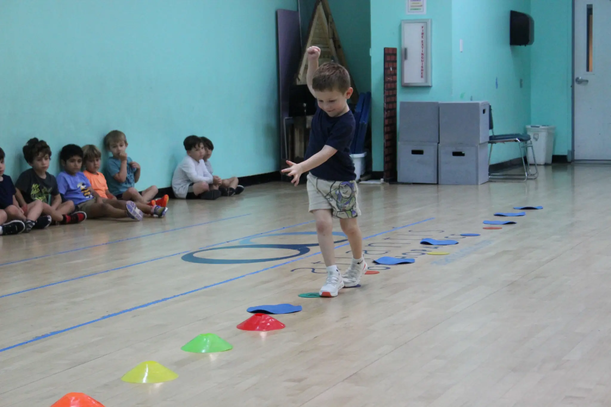 Preschool child participating in a movement and coordination activity during JCC hours and early childhood fitness programs