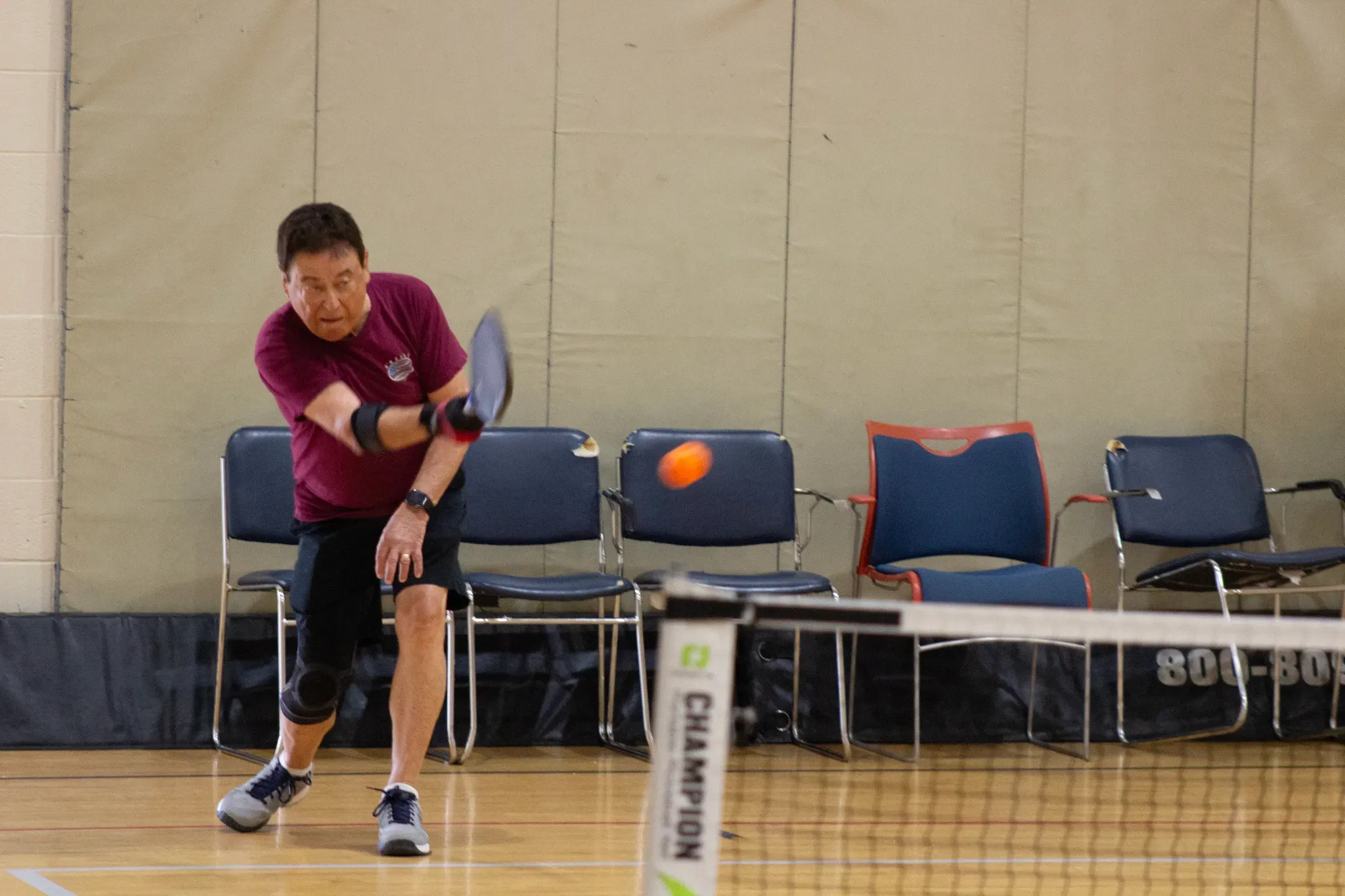 Participant returning the ball during pickleball lessons in boynton beach at the Mandel JCC fitness center