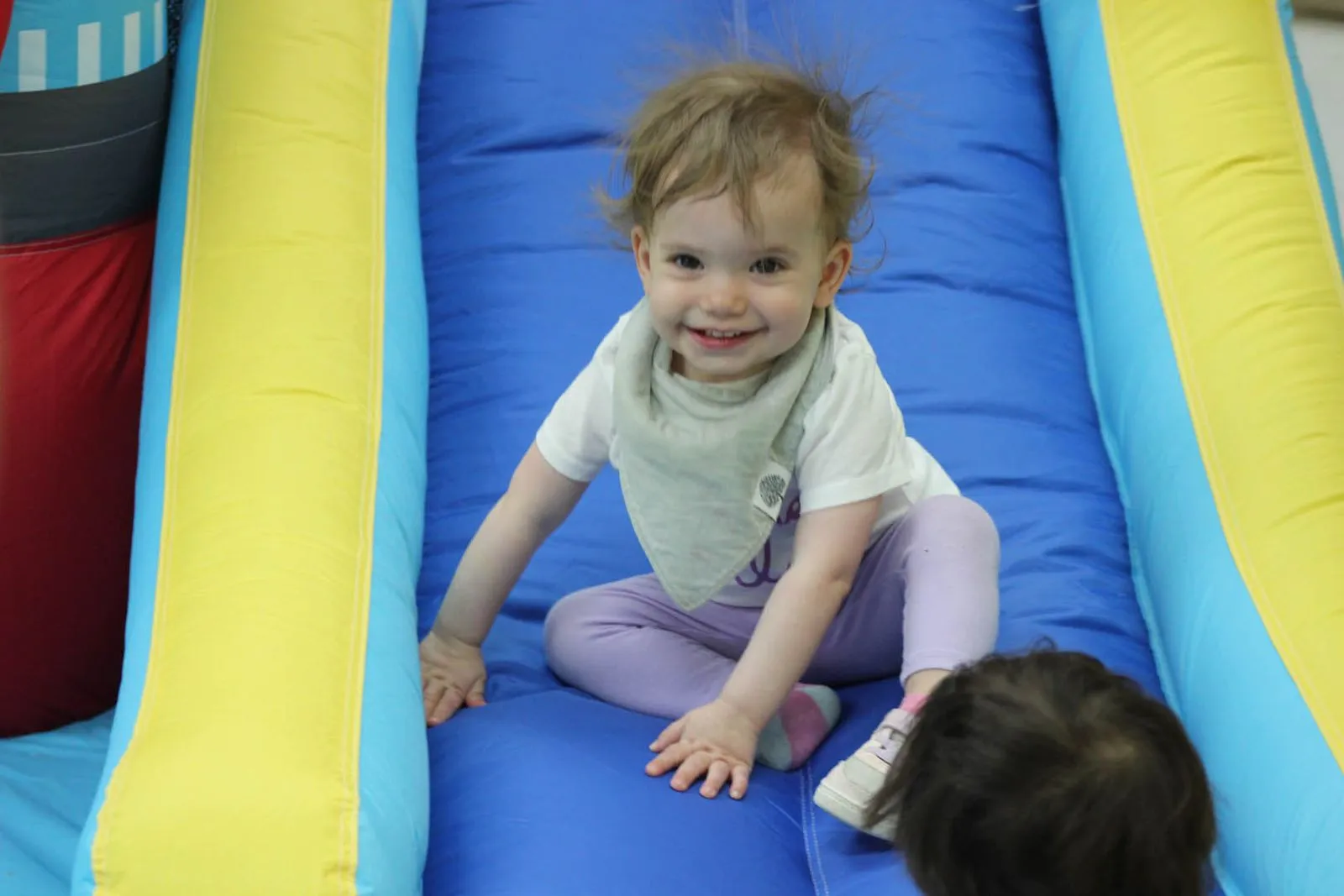 toddler smiling on soft slide at daycare preschool boynton beach fl