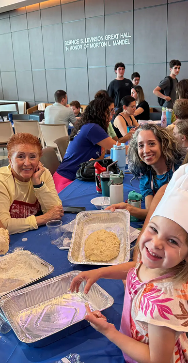 parents and children sit at community table during cooking class activity at preschool boynton beach fl