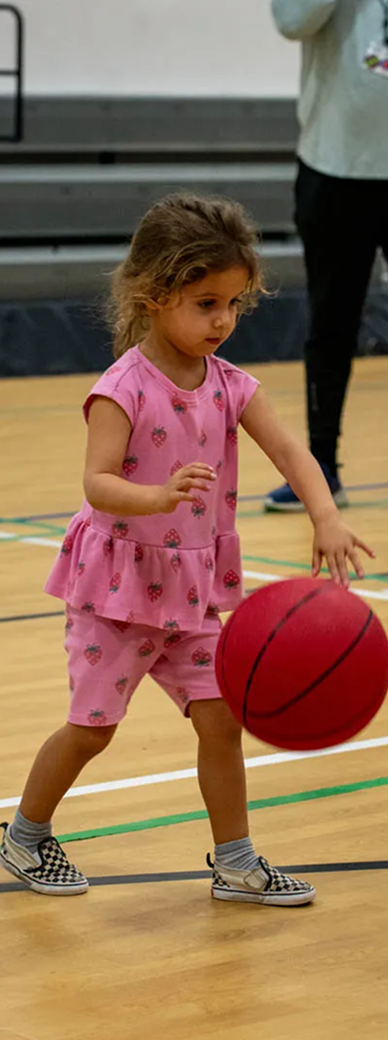 preschool girl dribbles basketball at palm beach gardens fl preschool