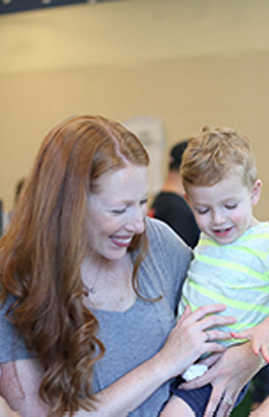 smiling parents and child connect at preschool community events to foster support