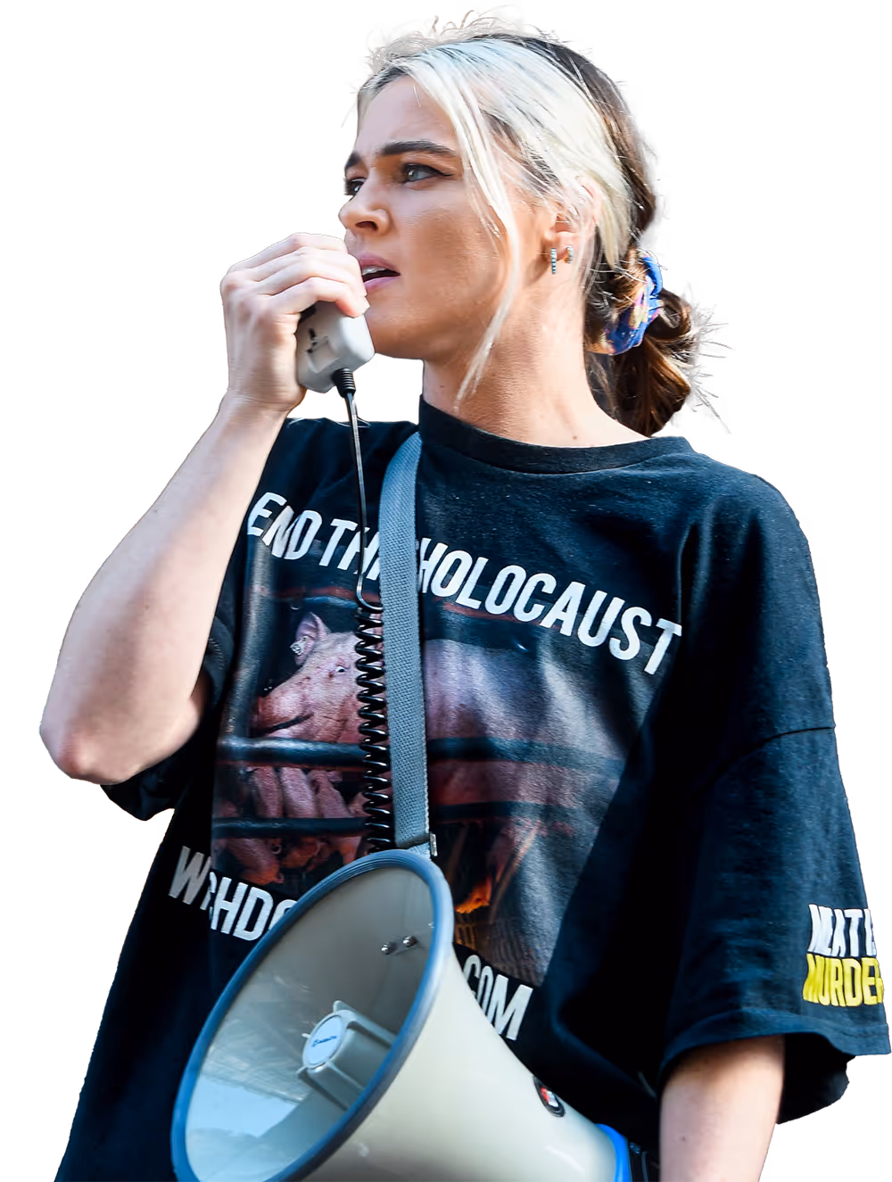 Tash speaking into a megaphone while wearing an animal rights shirt