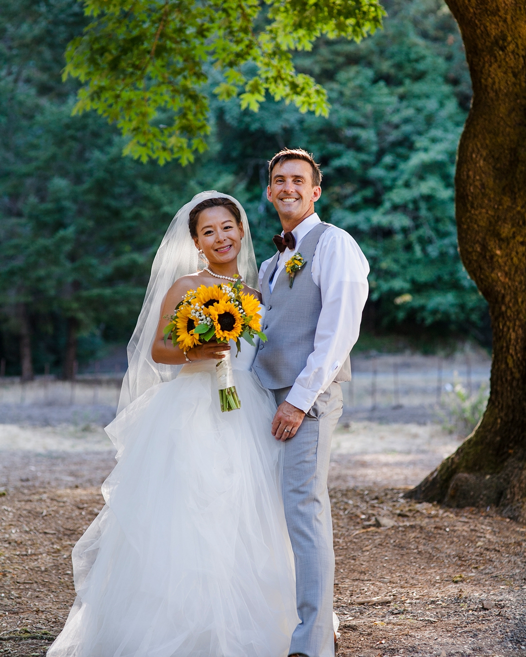 Beautiful married couple in front of scenic forest in wine country