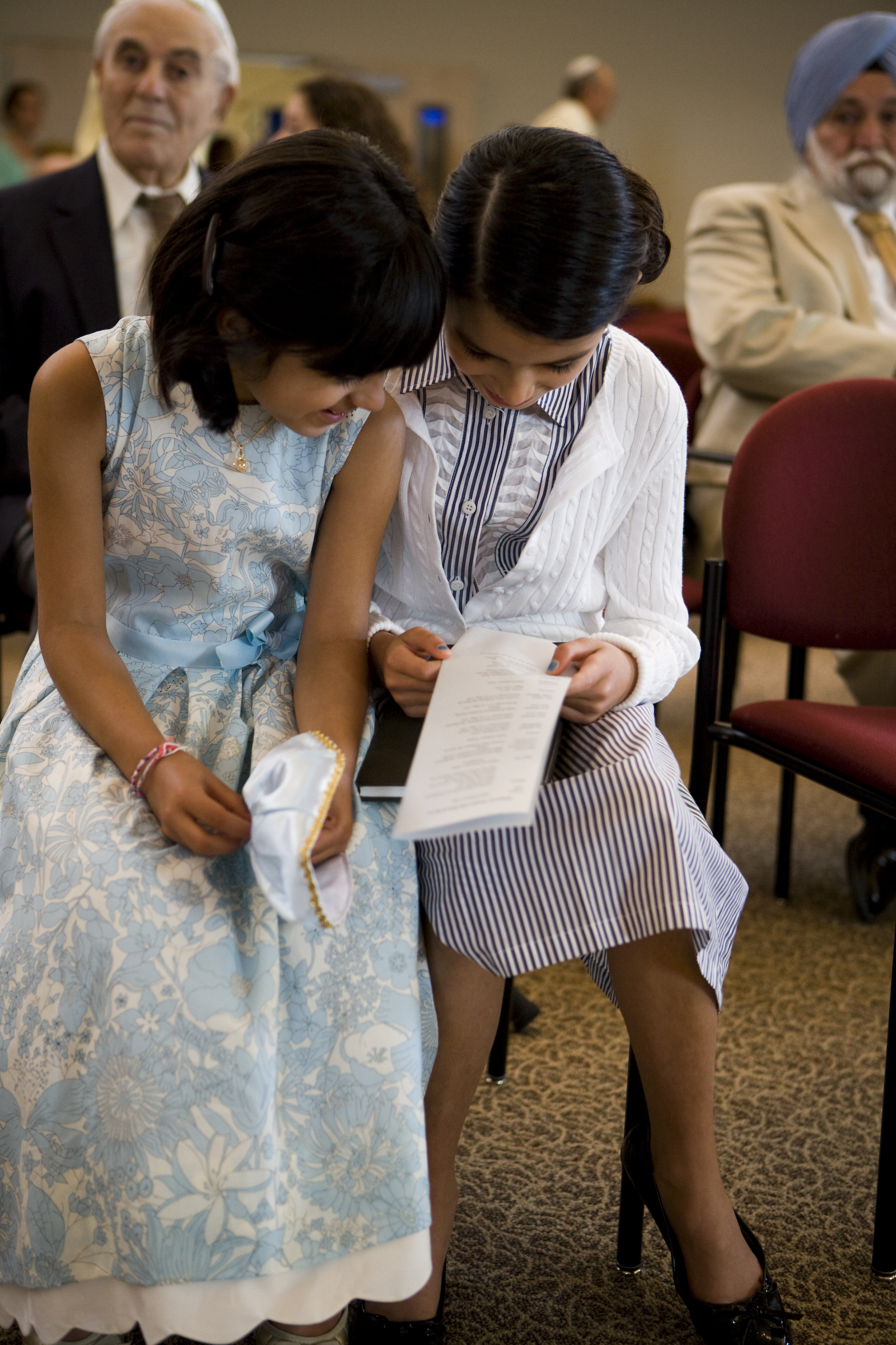Two young people at Mitzvah event reading