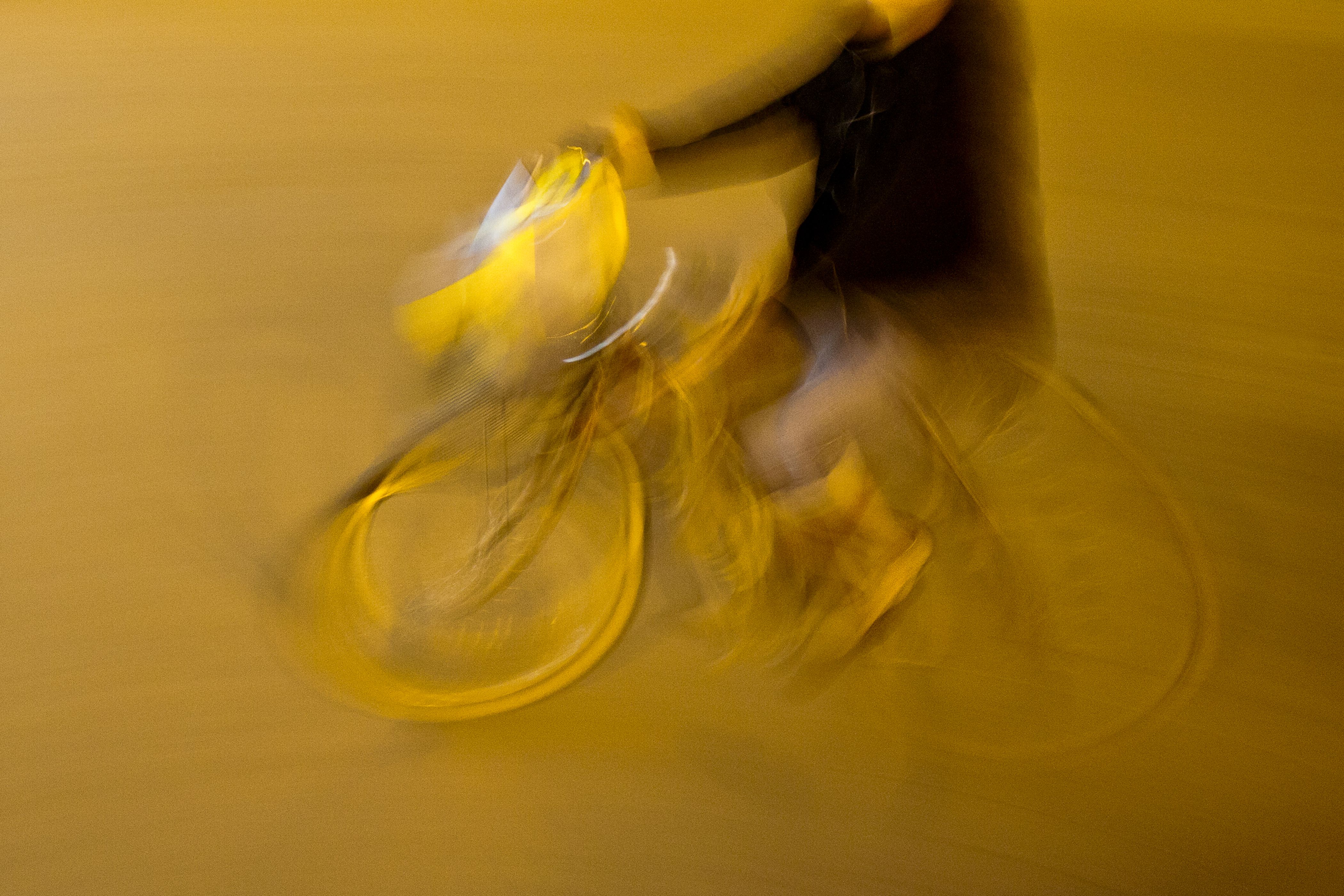 A motion blur photo of a person on a bike