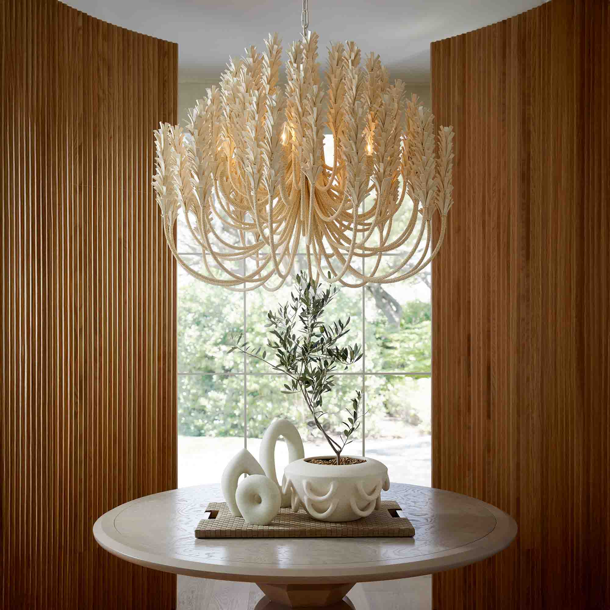 Close-up of a decorative chandelier with multiple hanging textured glass pendants on gold chains.