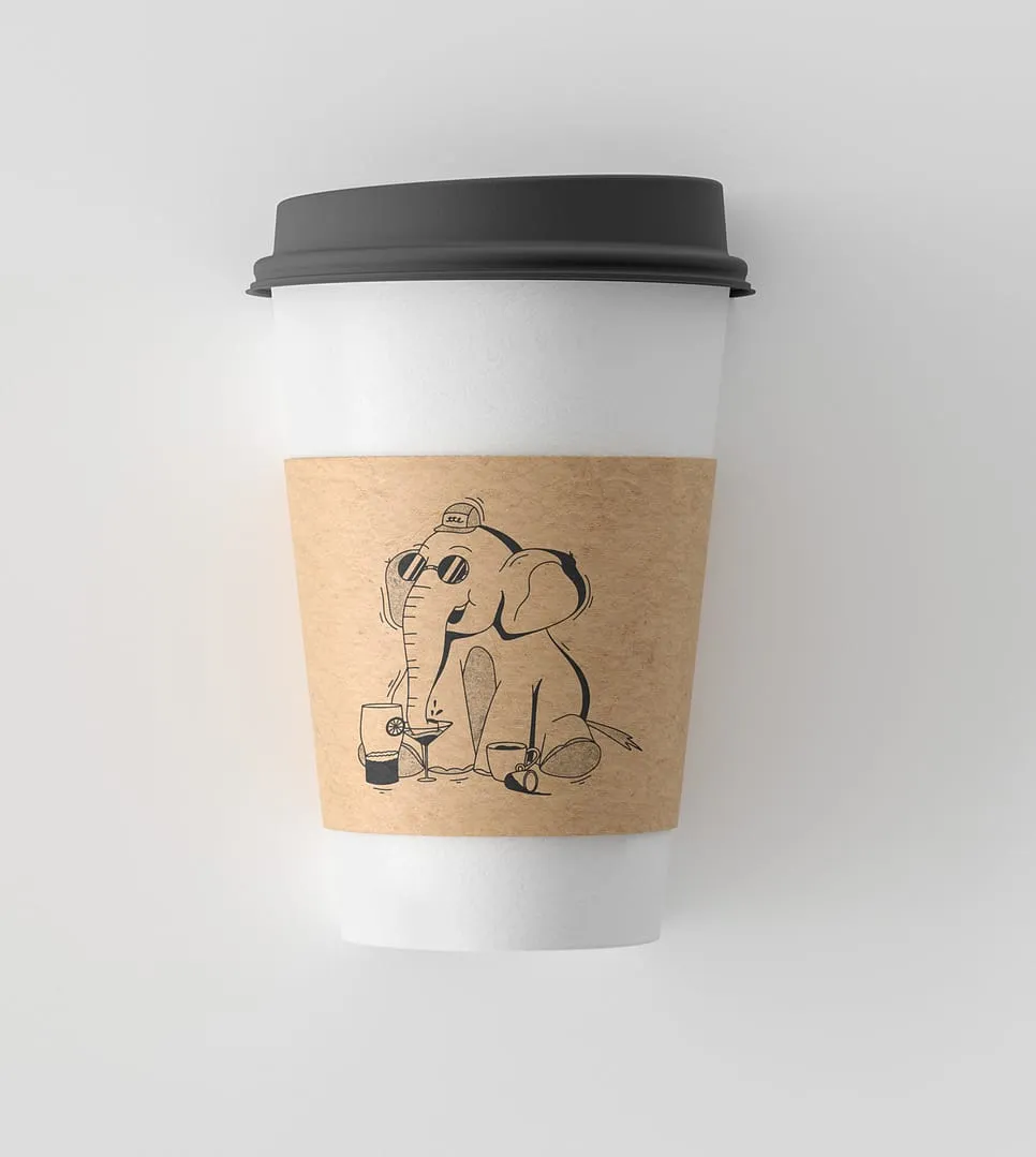White disposable coffee cup with black lid and brown sleeve featuring a cartoon elephant wearing sunglasses and a cap, drinking from multiple glasses.