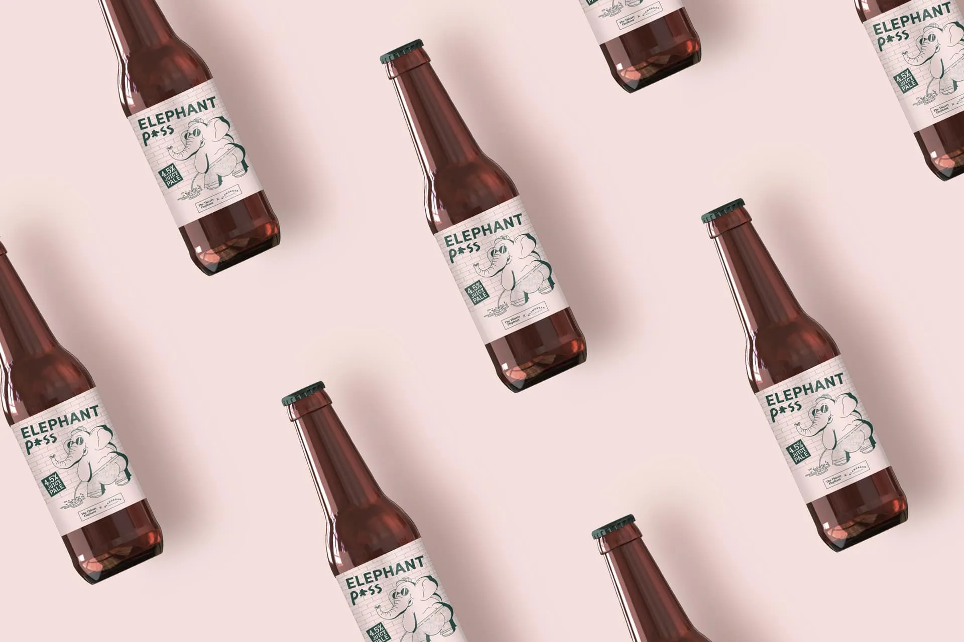 Bottles of Elephant Piss 4.5% Juice Pale Ale beer with a cartoon elephant on the label, arranged on a light pink background.
