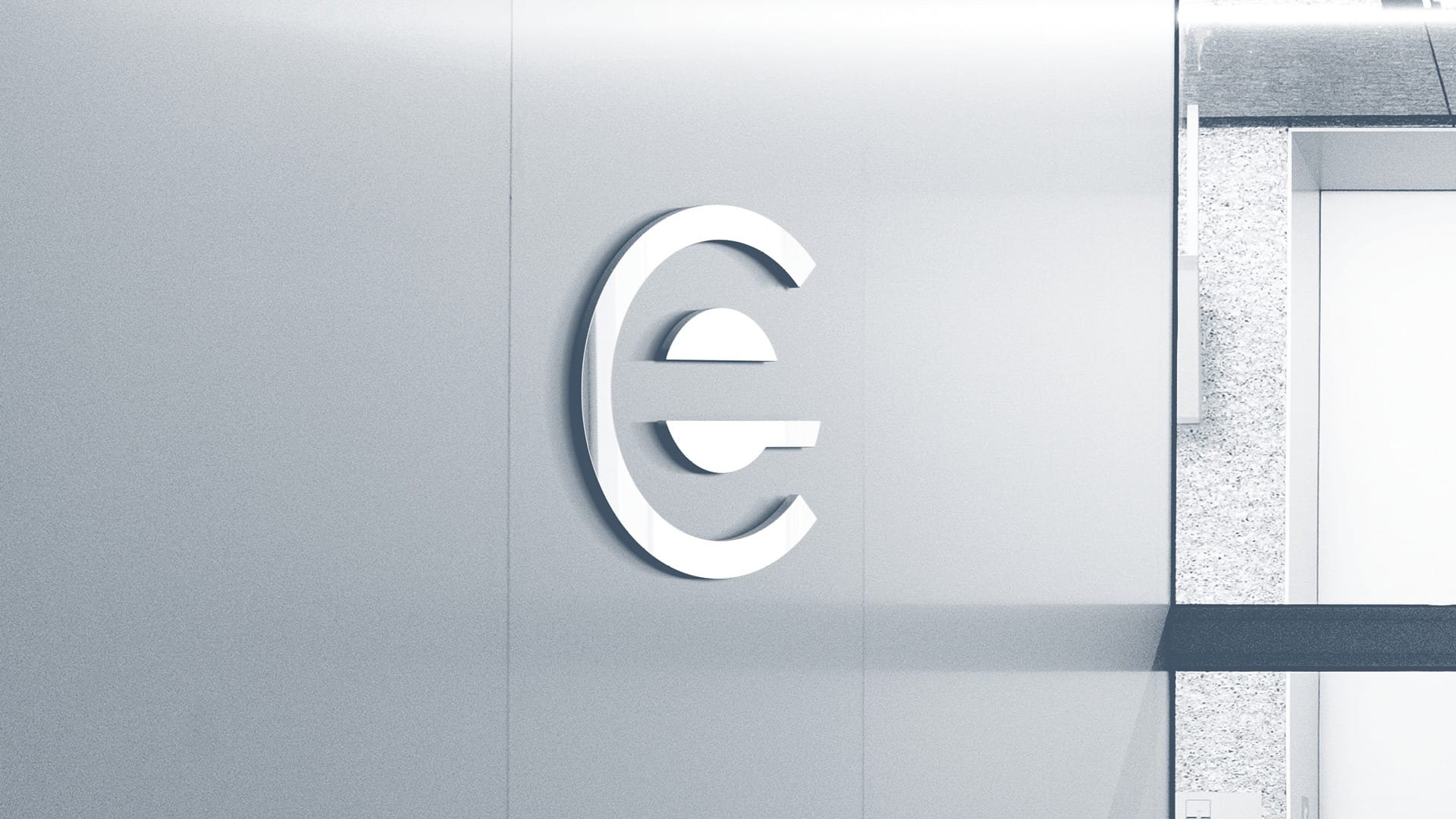 White Euro currency symbol mounted on a gray wall in a modern interior.