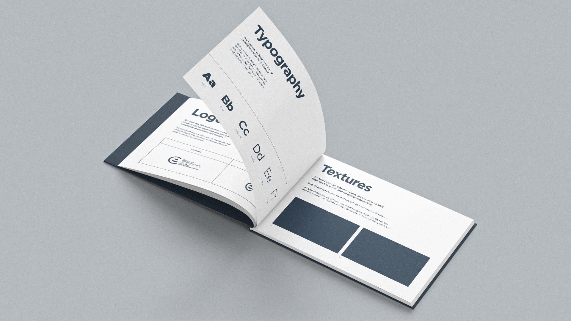 Open booklet displaying pages with typography styles, logo guidelines, and texture samples in a clean, minimalist design.