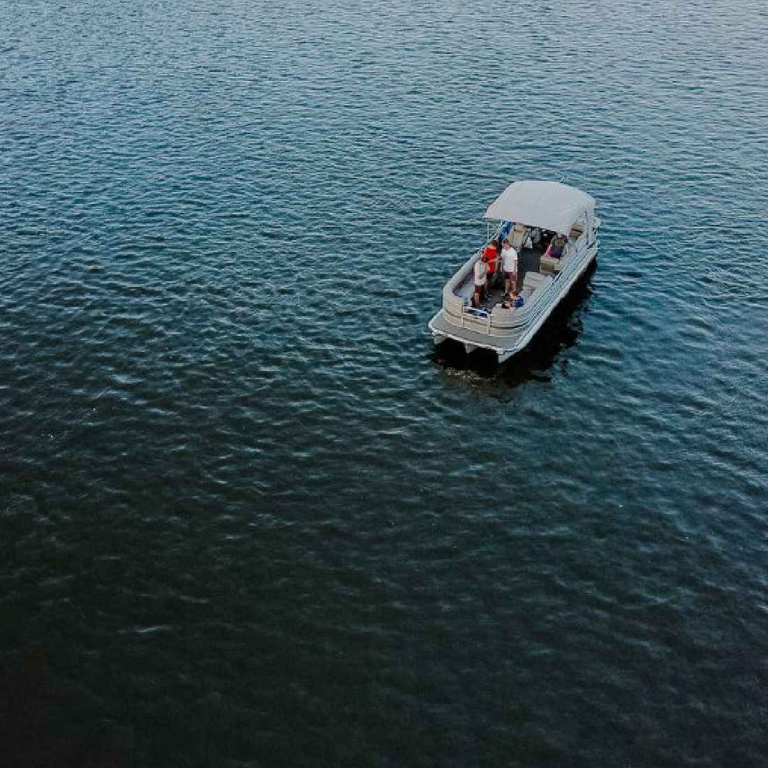 Aerial view of a pontoon boat on a lake