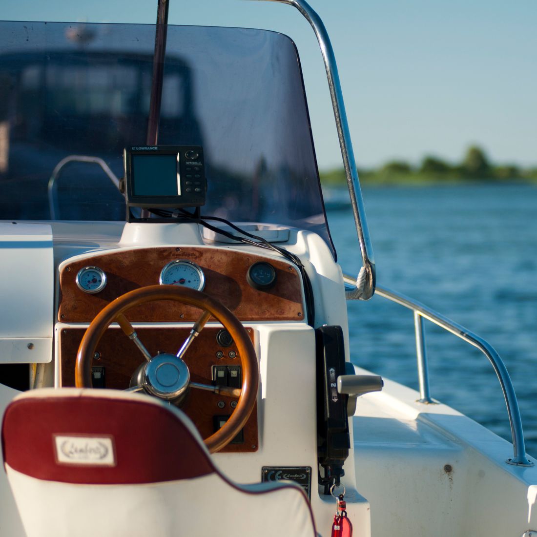 Close-up of a boat's steering wheel and dashboard
