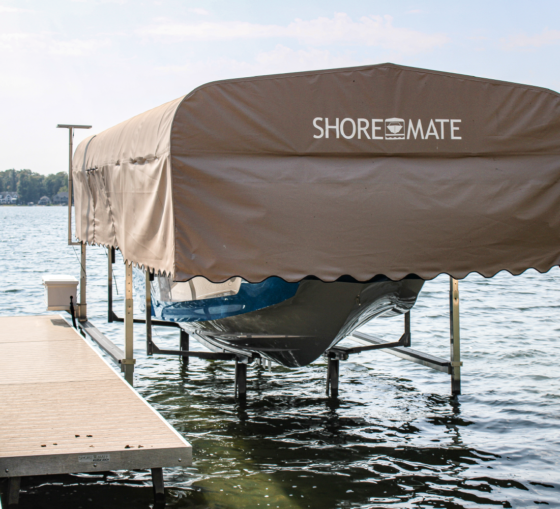 ShoreMate canopy boat lift installed beside a dock on a West Michigan lake