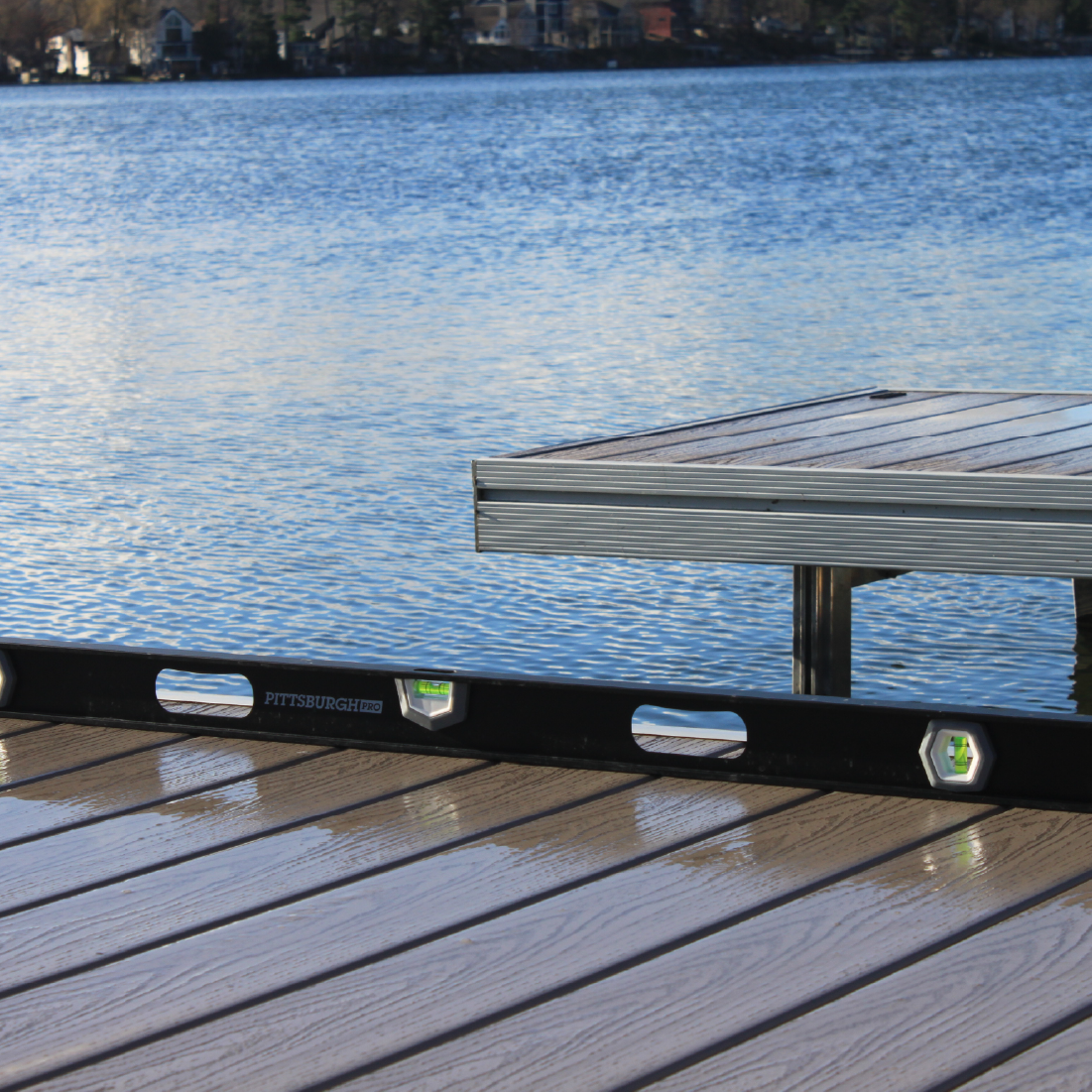 Close-up of aluminum dock sections over clear lake water