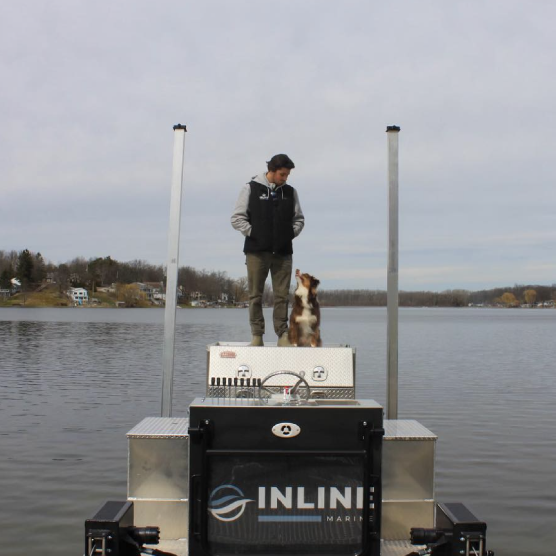 Inline Marine team member and dog standing on a lakefront dock