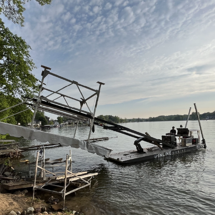 Dock and boat lift sections staged on the shoreline for seasonal installation