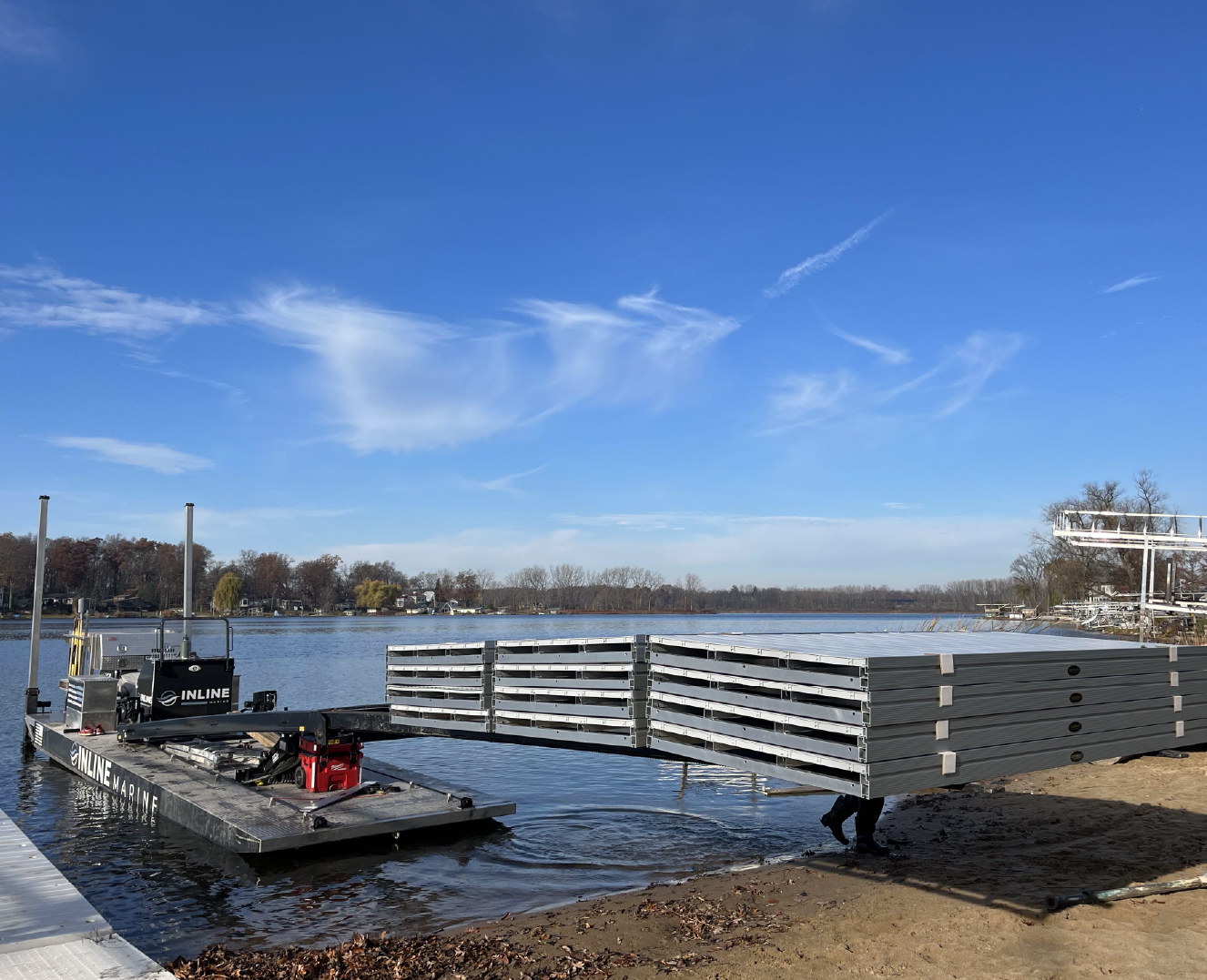 Barge transporting dock and lift equipment across a West Michigan lake