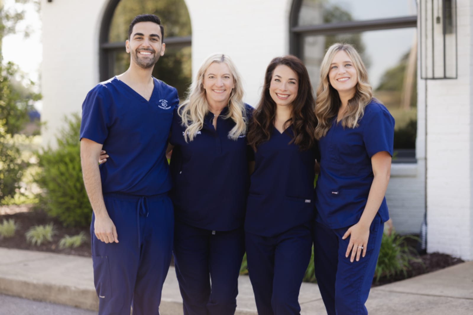 Holly Tree Pediatric Dentistry team of four staff members posing together outdoors