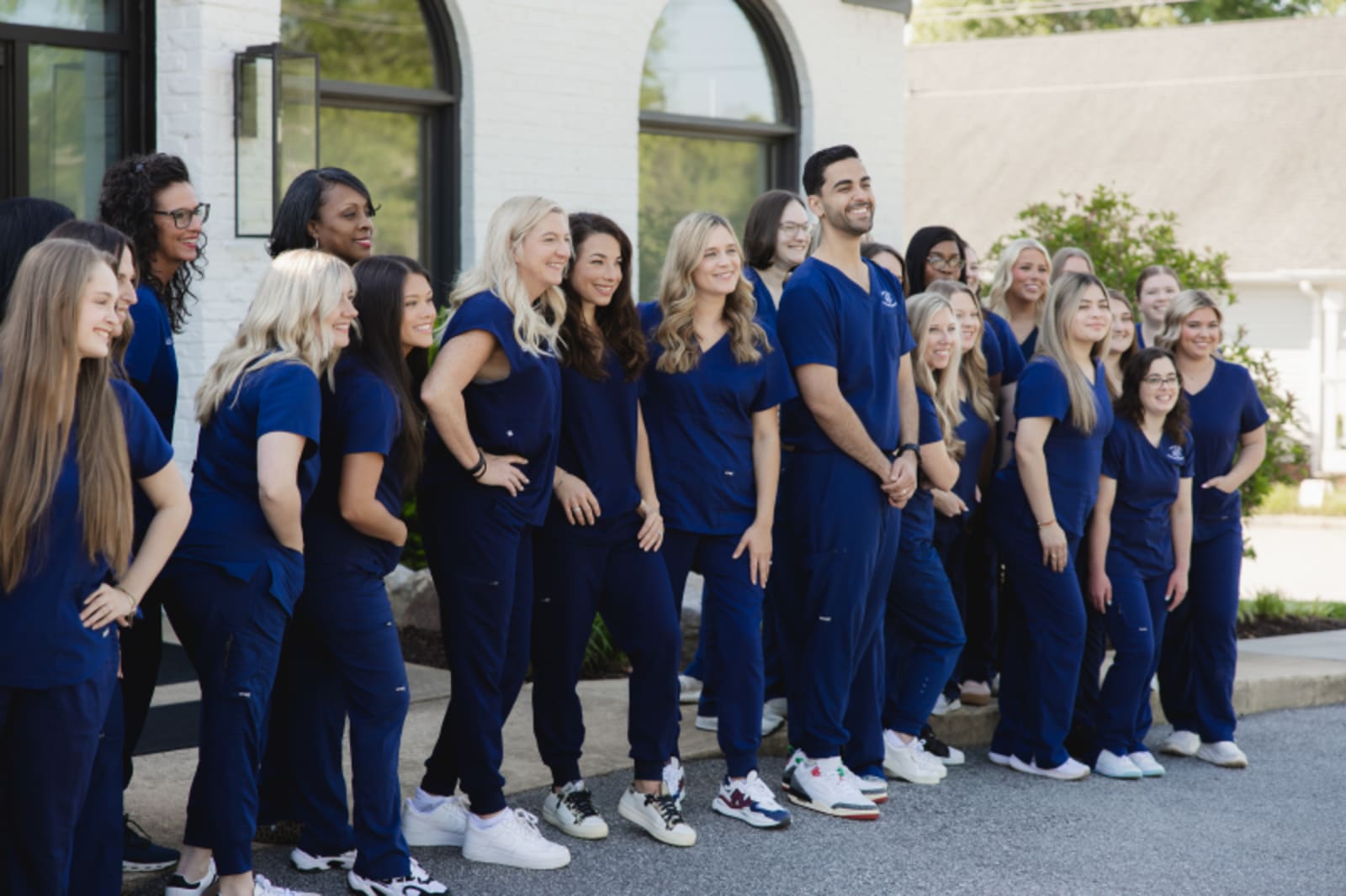 Holly Tree Pediatric Dentistry team in blue uniforms standing together outside