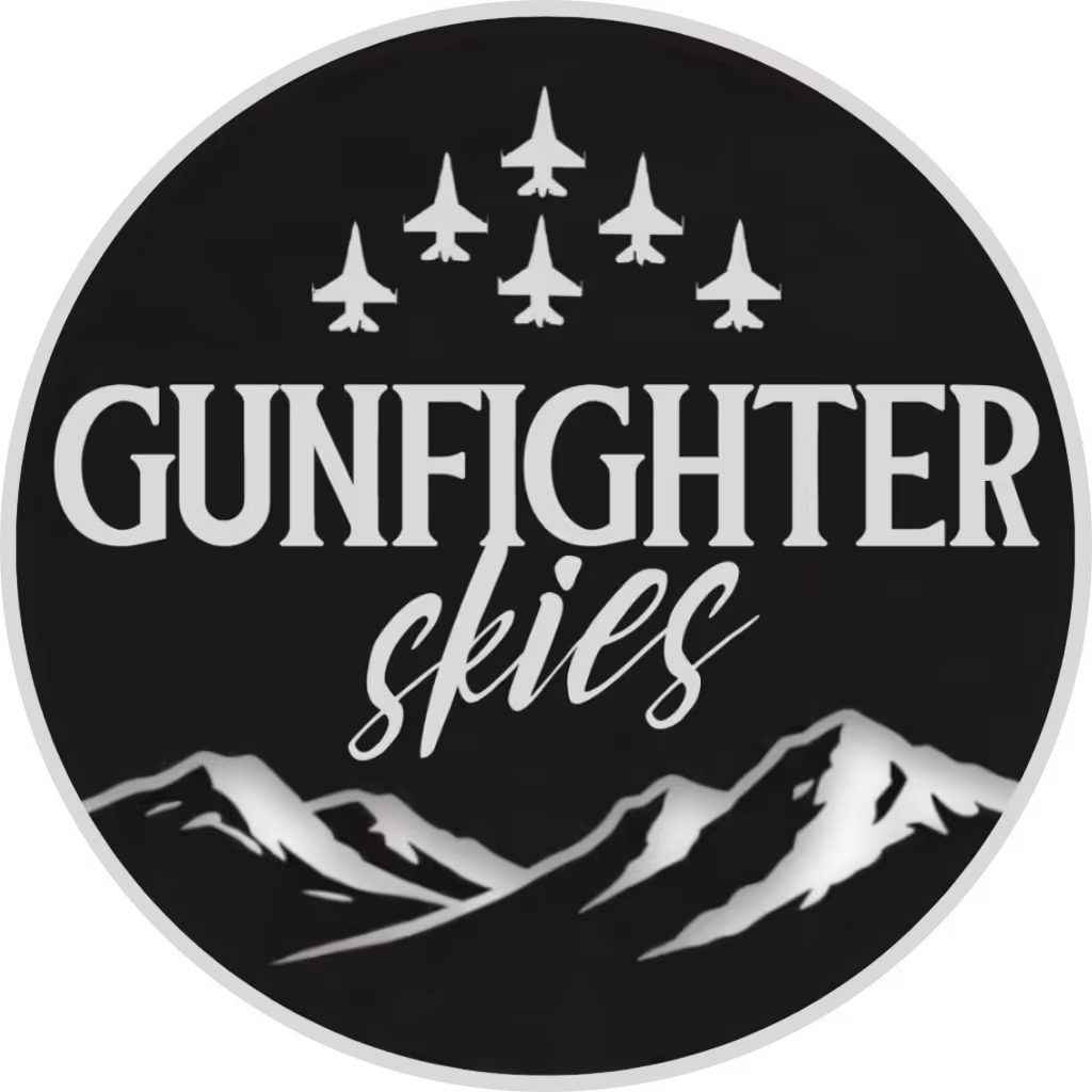 Logo with six fighter jets flying in formation above the text 'GUNFIGHTER skies' and stylized mountains below on a black circular background.
