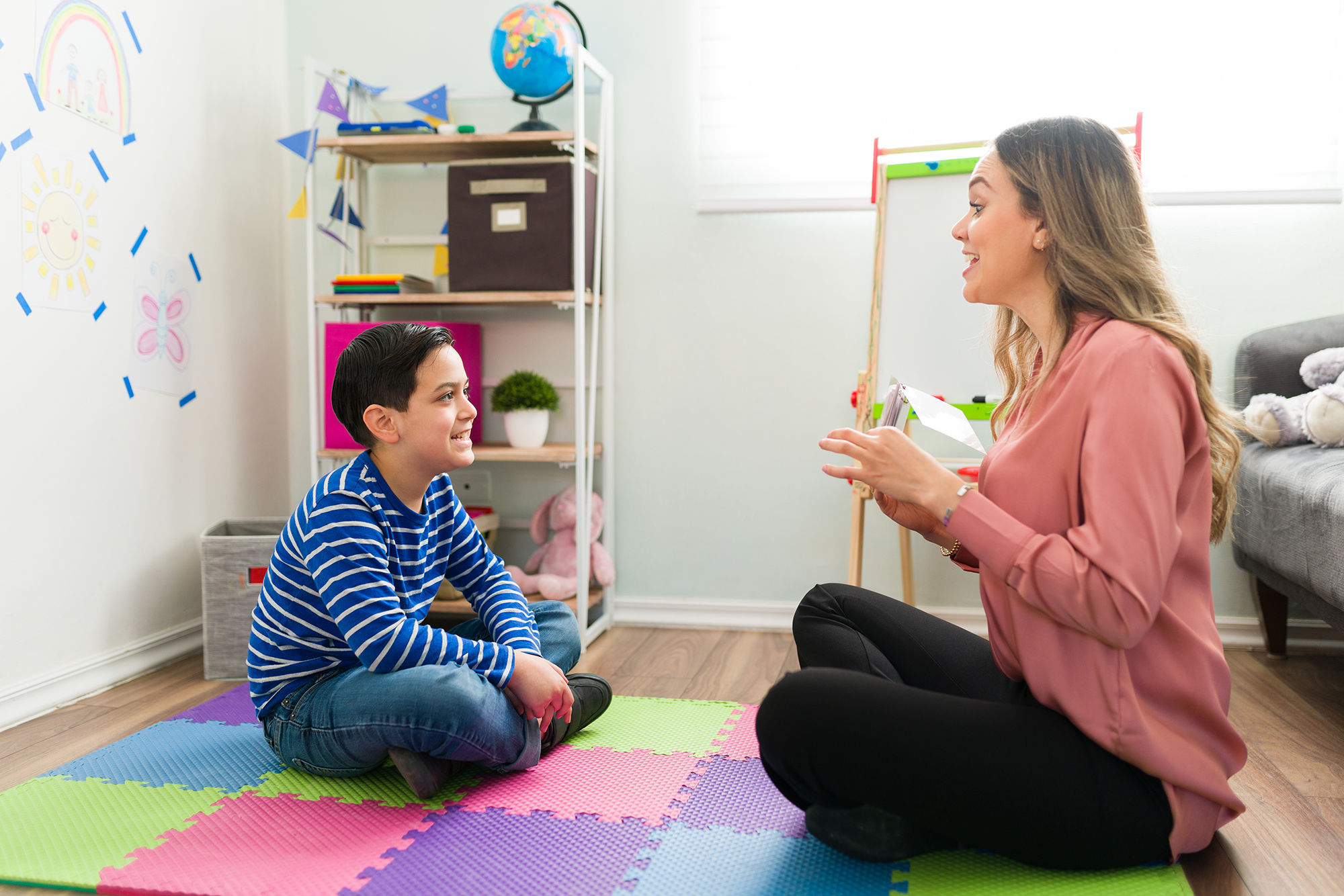 A child working with a therapist in an early intervention session, representing DDS Children's Programs