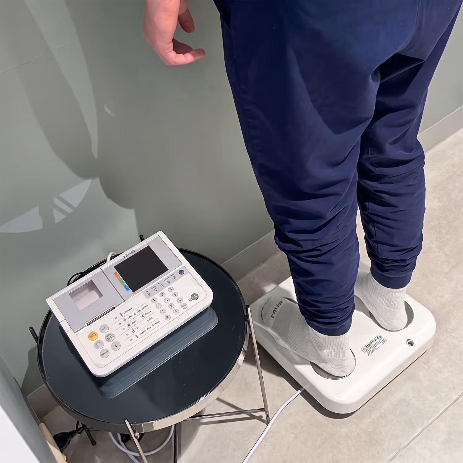 A patient stepping on a metabolic scale before the procedure.