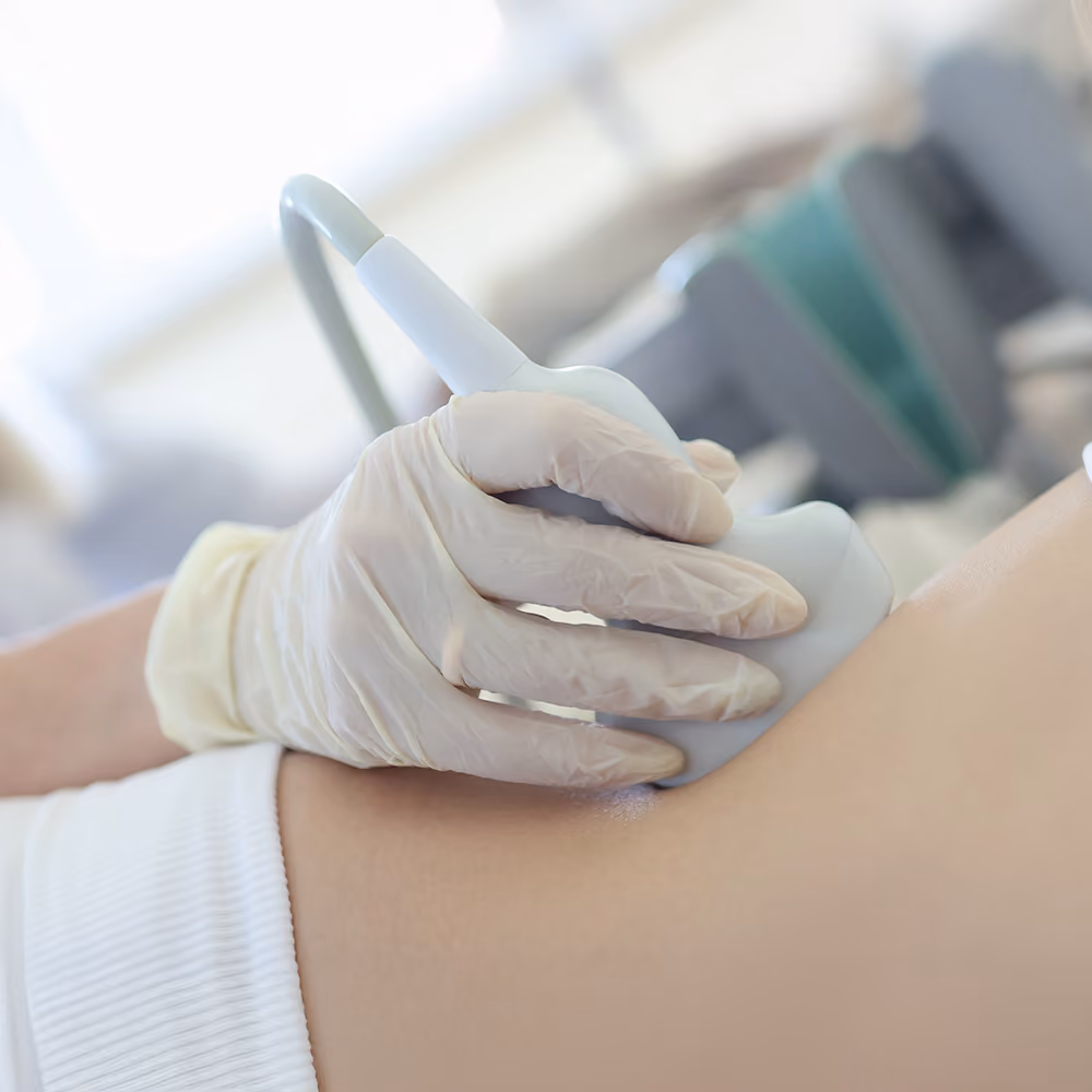 Healthcare professional performing a liver ultrasound scan to assess iron overload and liver damage associated with hereditary haemochromatosis.