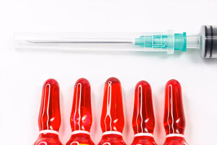 Vitamin B12 injection ampoules and a syringe prepared for intramuscular administration to treat or prevent vitamin B12 deficiency.