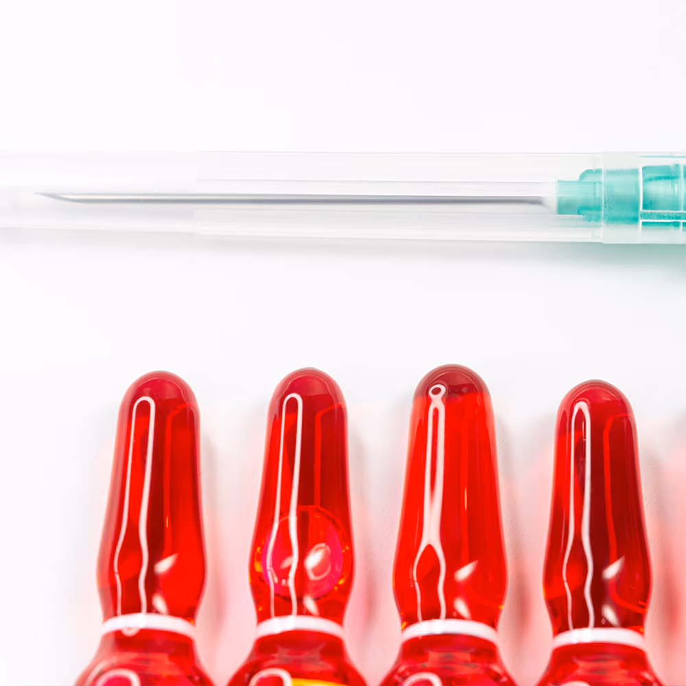 Vitamin B12 injection ampoules and a syringe prepared for intramuscular administration to treat or prevent vitamin B12 deficiency.