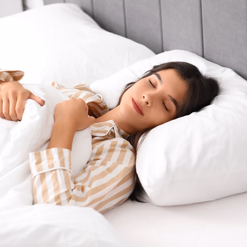 Person resting comfortably in bed after a medical procedure.