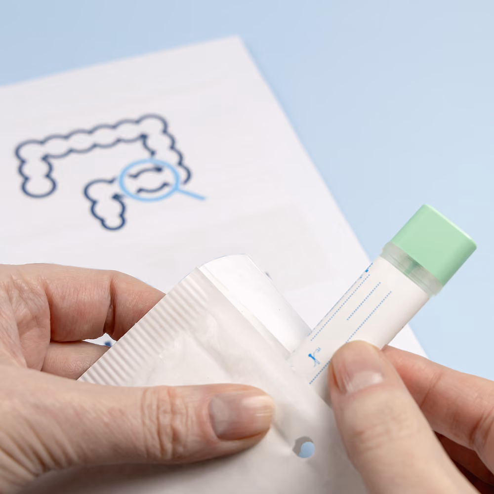 Person preparing a bowel cancer screening stool sample collection kit for home testing.