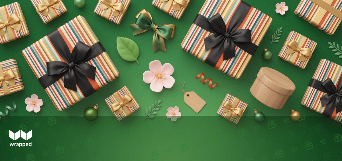 A curated gift box with a book, bracelet, and chocolate arranged on a warm wooden surface