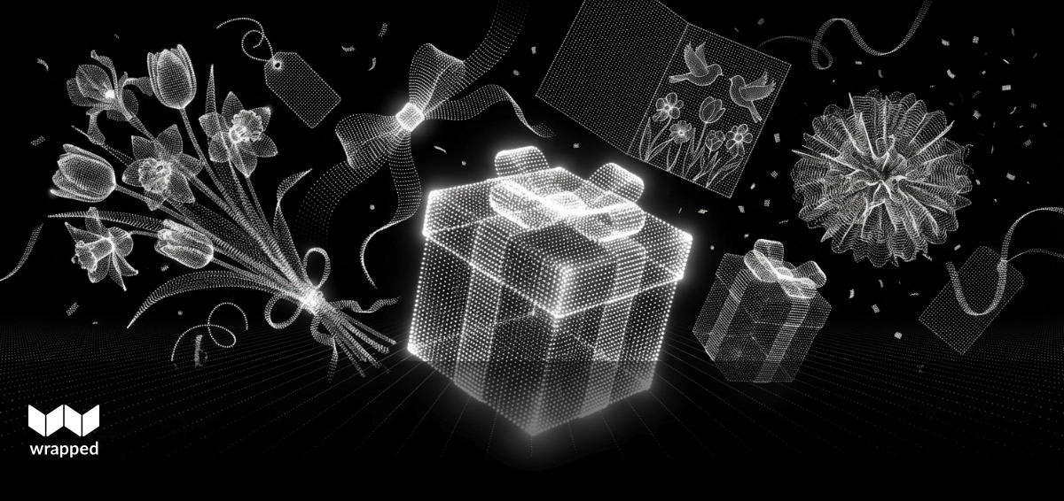 A custom printed gift box with a handwritten note tucked inside, surrounded by wrapping paper and ribbon on a wooden table