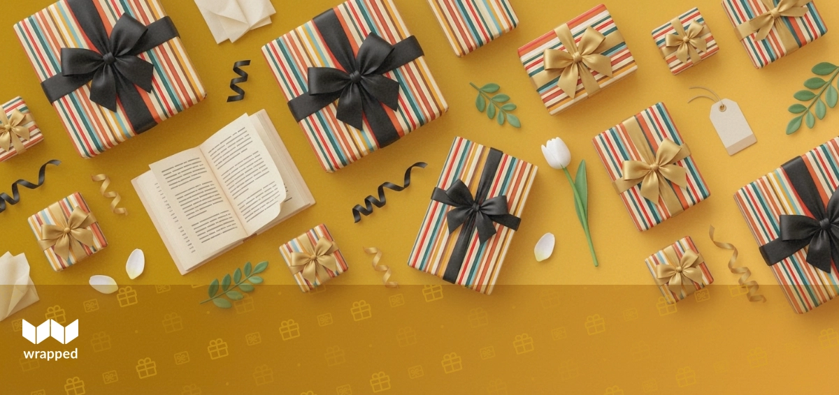 A wrapped book with a handwritten gift note tucked inside, sitting on a spring table with flowers