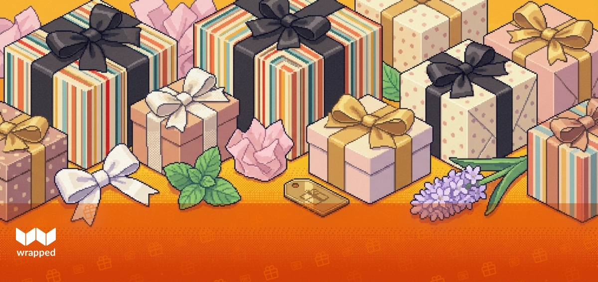 A curated gift box filled with small wrapped items sitting on a kitchen table in spring light