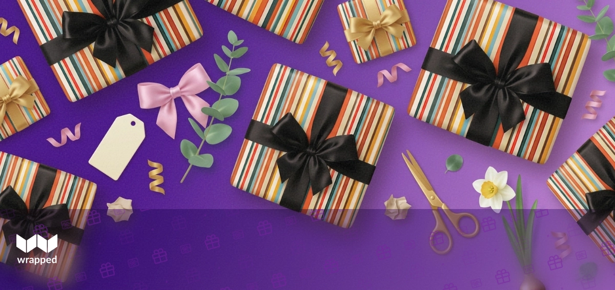 A beautifully wrapped gift box with a handwritten card and ribbon on a spring table setting