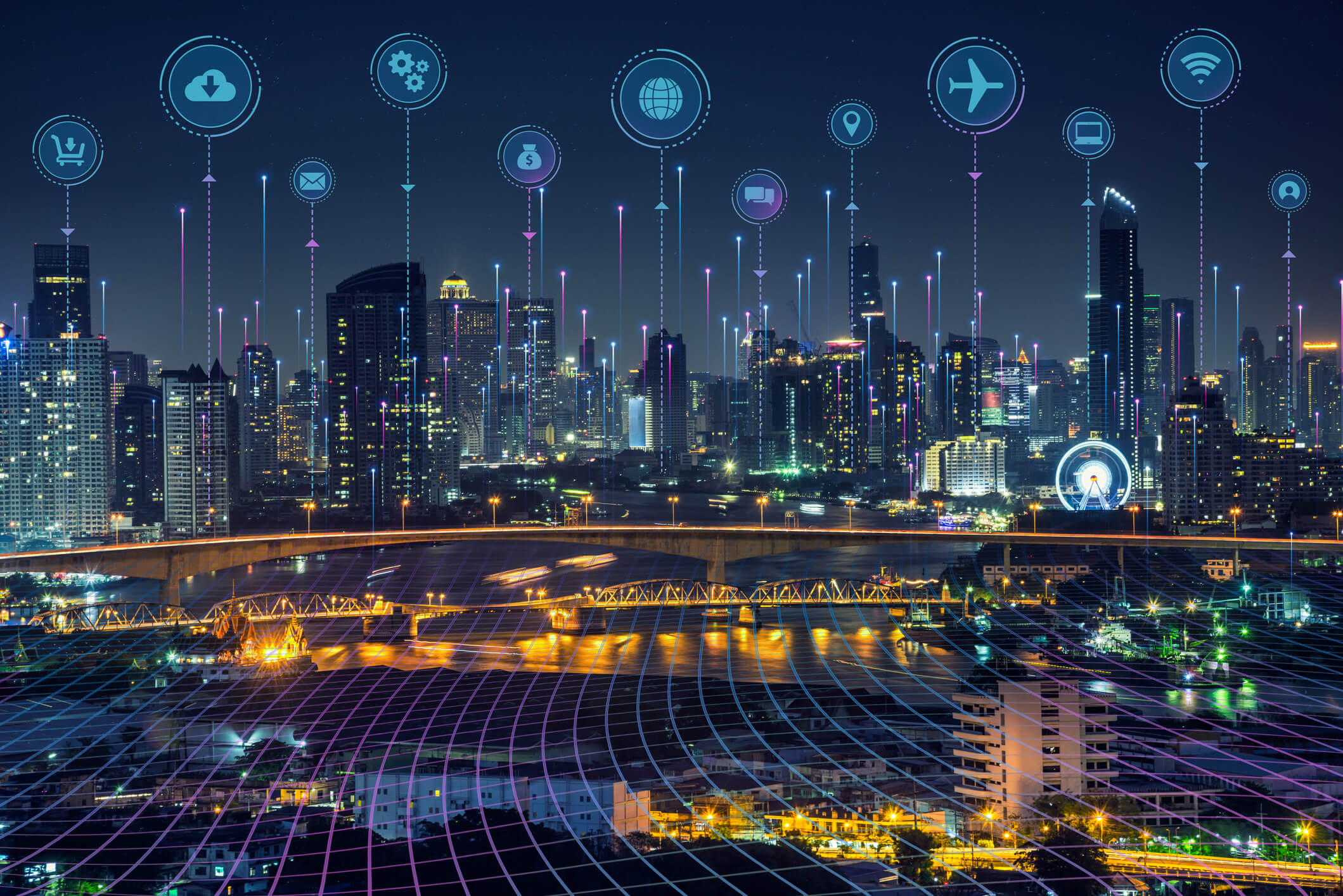 Night city skyline with illuminated buildings and bridges over water, overlaid with digital icons representing cloud download, gears, email, finance, global network, chat, location, airplane, laptop, wifi, and user, connected by glowing lines indicating technology and communication networks.
