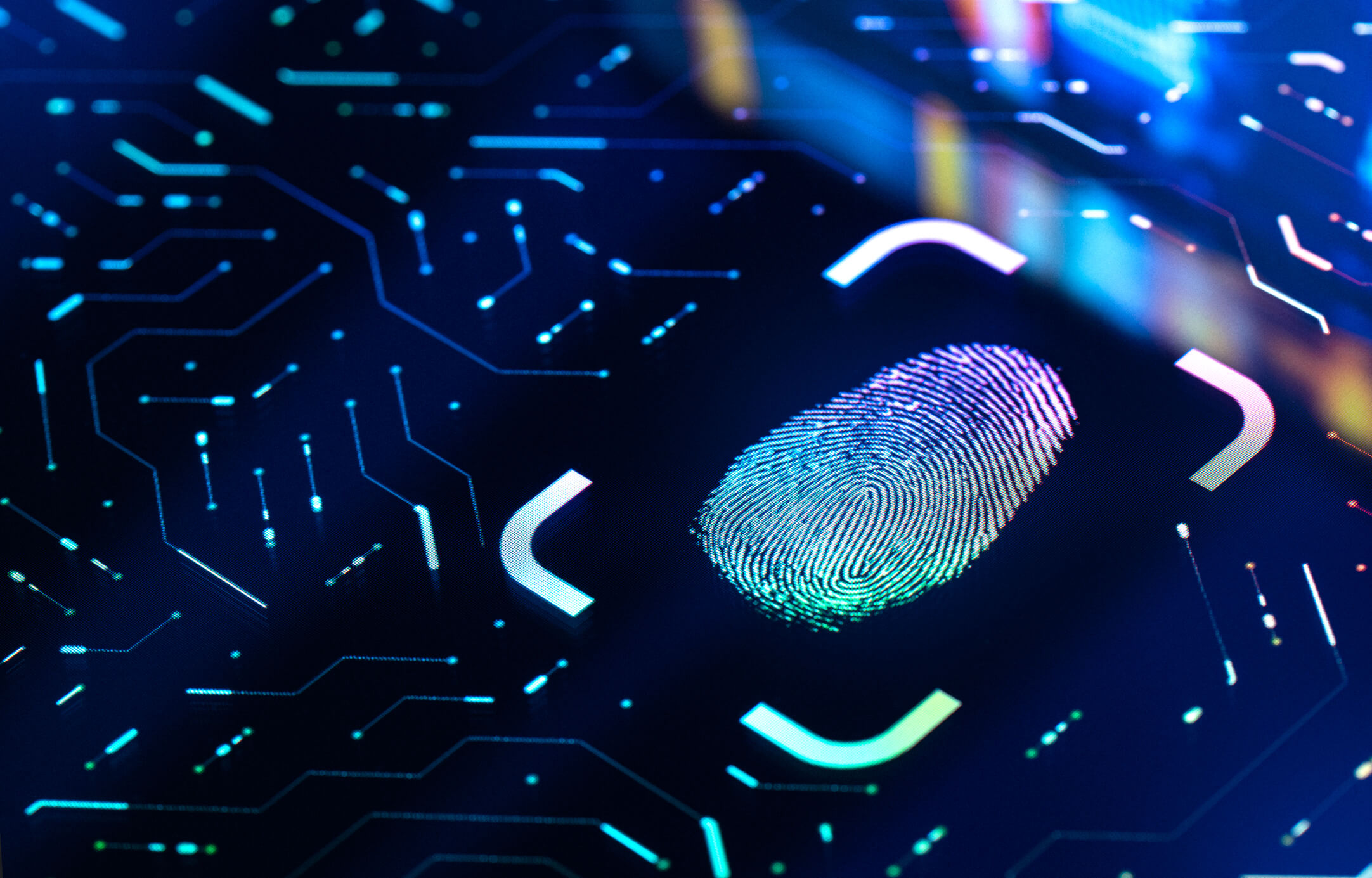 Close-up of a colorful digital fingerprint on a dark background with illuminated circuit lines, symbolizing biometric security and technology.