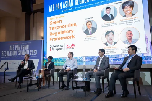 Five panelists seated on stage at the ALB Pan Asian Regulatory Summit 2023, with a large screen behind them showing the panel session titled 'Green Taxonomies, Regulatory Framework' and photos and names of the moderator and panelists.