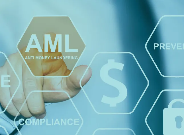 Person's hand pointing to a hexagonal button icon labeled 'AML ANTI MONEY LAUNDERING' on a transparent digital interface with other icons and terms like compliance, dollar sign, and prevention in the background.