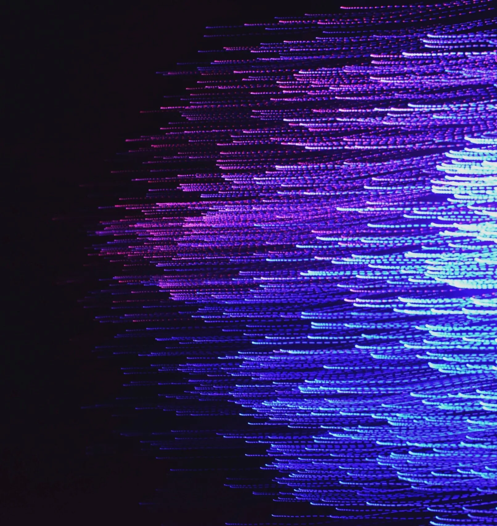Abstract digital art featuring numerous neon blue and purple light trails against a black background, creating a sense of dynamic movement and flow.