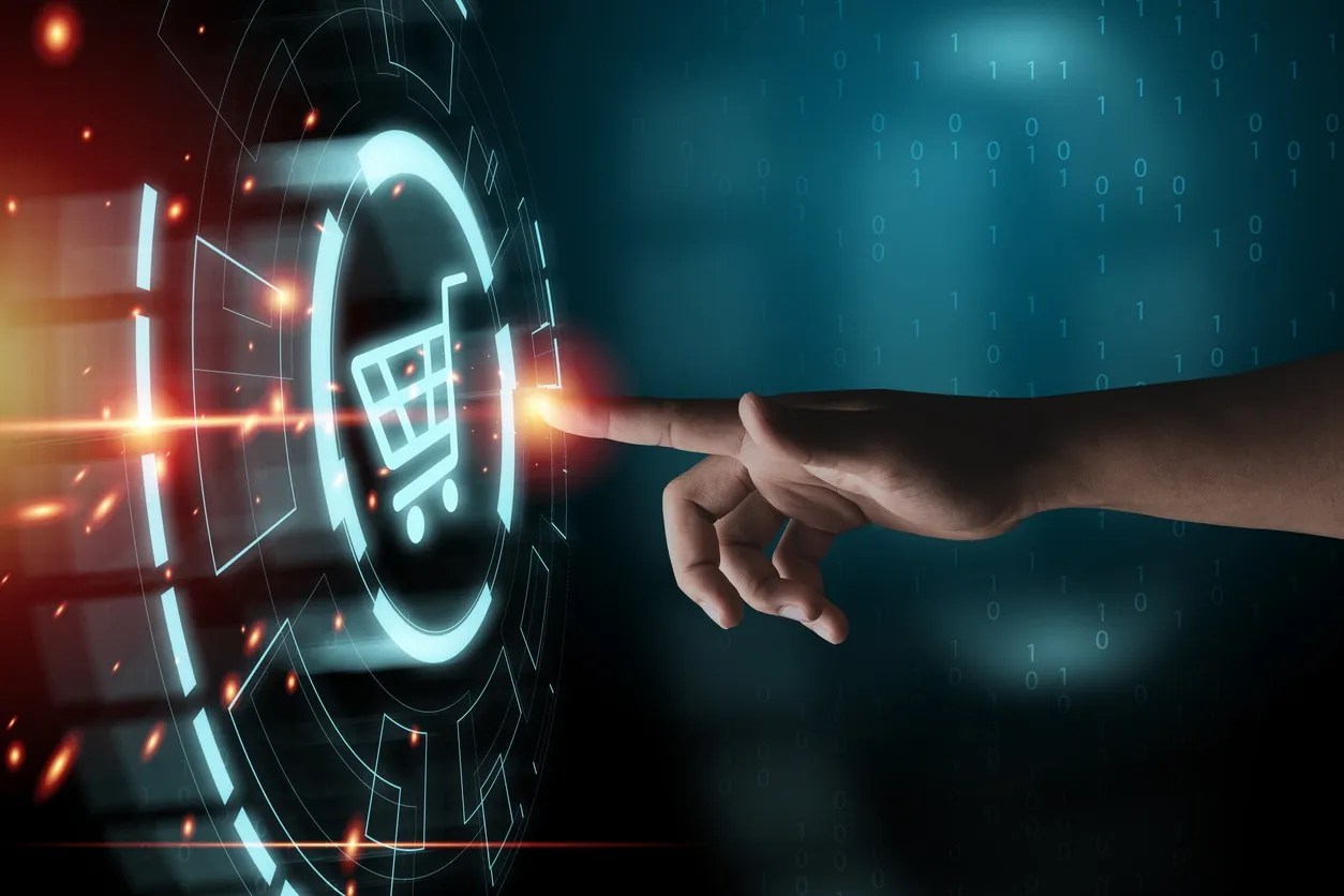 Human hand with extended index finger touching a glowing digital shopping cart icon surrounded by futuristic circular interface elements and binary code in the background.