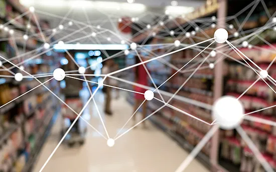 Blurred image of a supermarket aisle with shelves stocked on both sides and a person pushing a shopping cart, overlaid with a semi-transparent network of interconnected white nodes and lines symbolizing digital connectivity or data flow.