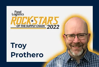 Portrait of Troy Prothero wearing glasses and a blue checkered shirt, featured in Food Logistics Rock Stars of the Supply Chain 2022 graphic.