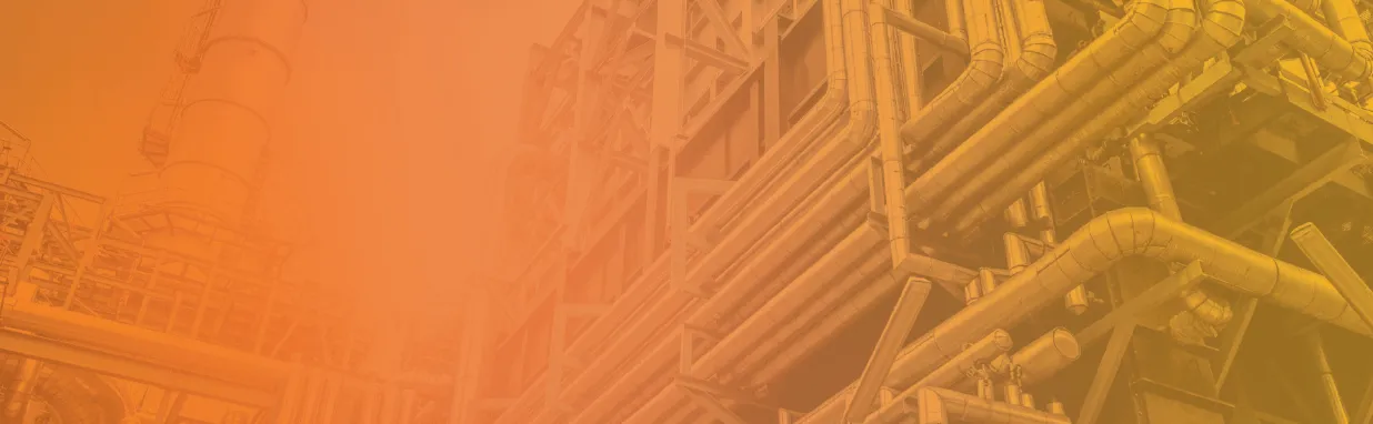 Industrial complex with network of metal pipes and structures, tinted with an orange overlay.