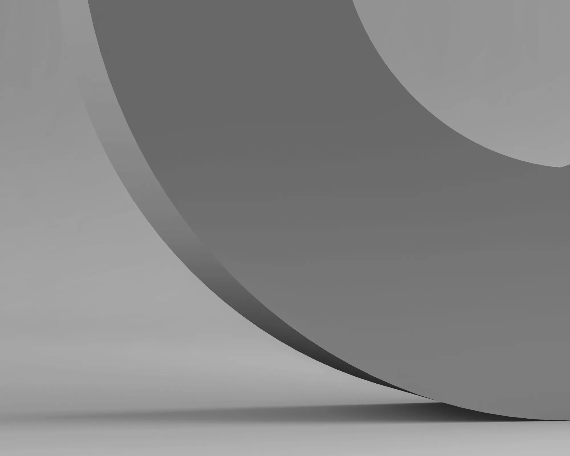 Close-up view of smooth, curved, gray abstract shapes creating a minimalist modern design with shadows.