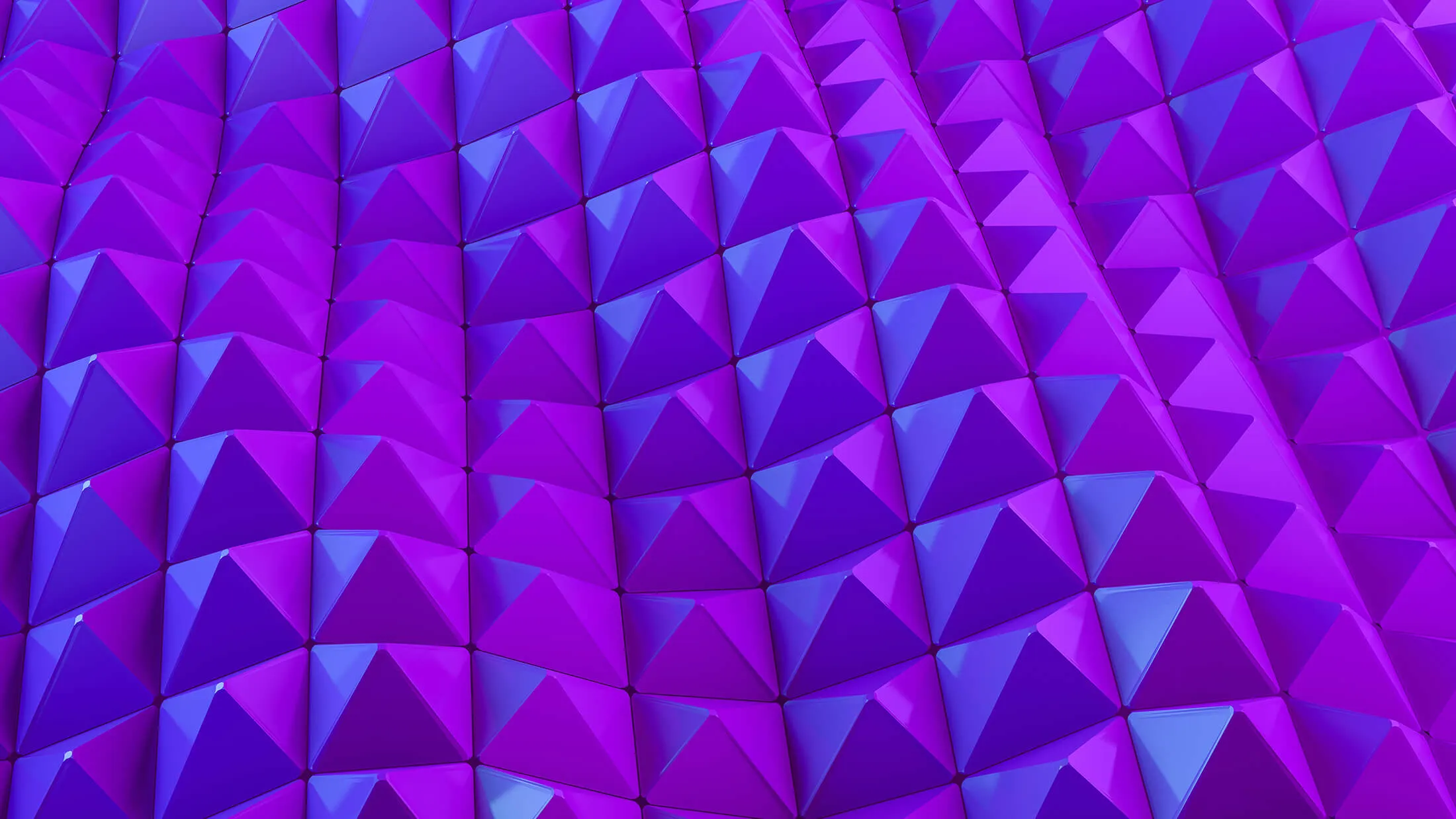 Abstract 3D pattern of purple and blue pyramid shapes forming a repeating geometric surface.