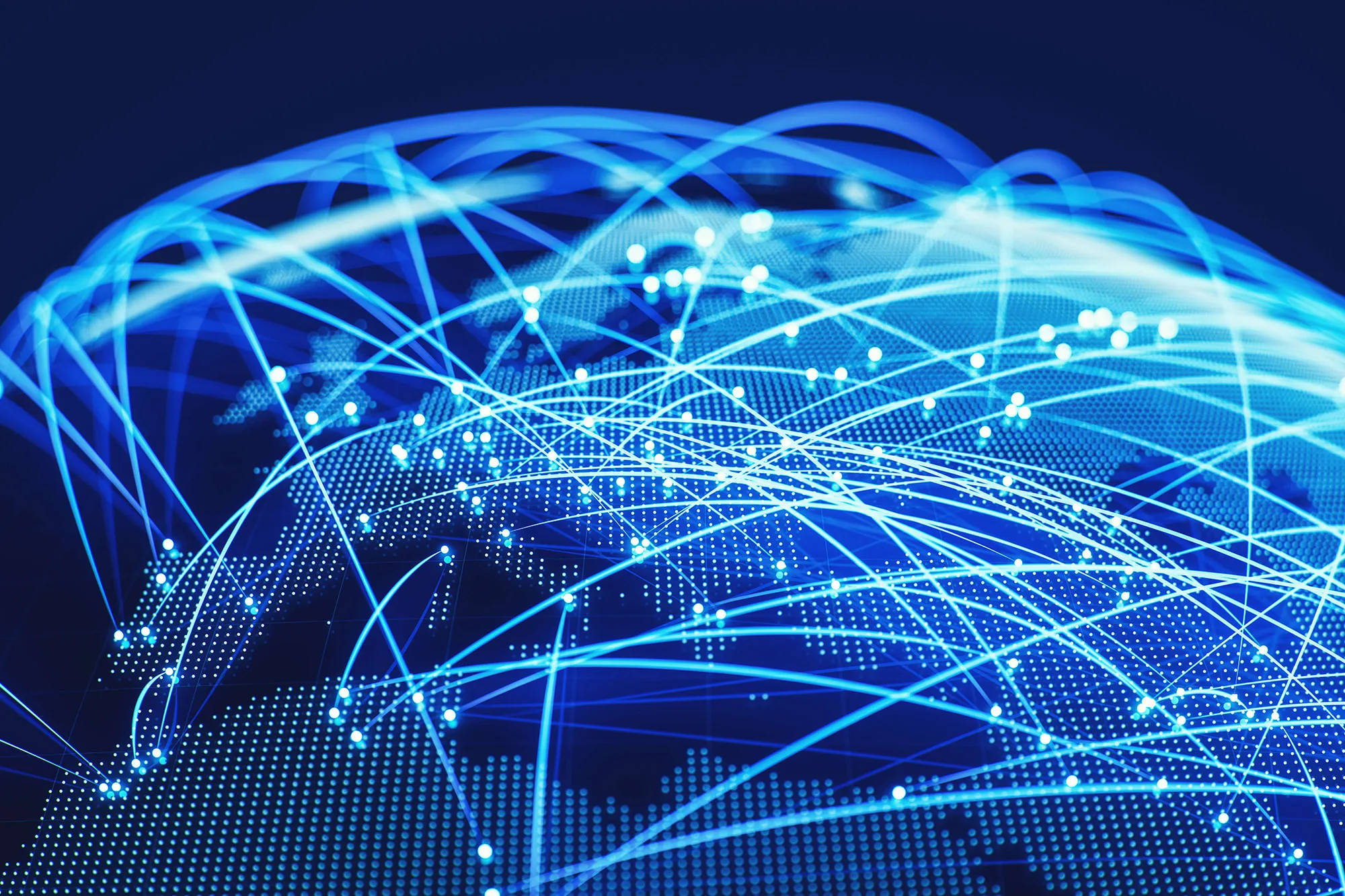 Digital globe with blue light trails and dots representing global network connections across continents on a dark background.